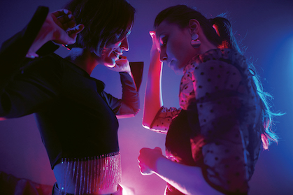 Two white ladies dancing next to each other