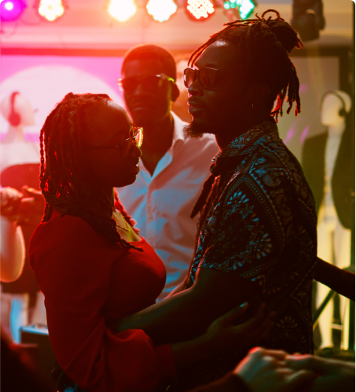 Two people standing in a group holding each other