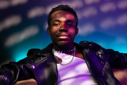 A black man sitting on a couch